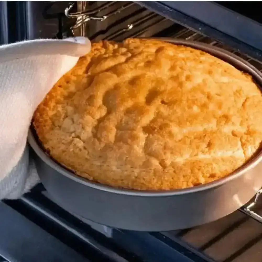 Baked pie being removed from an oven with a person wearing an oven mitt.