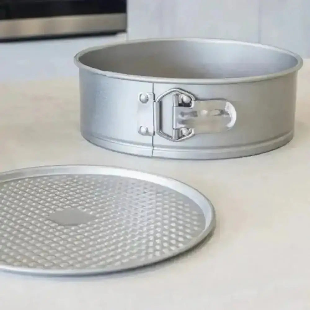 Metal springform pan on a white surface