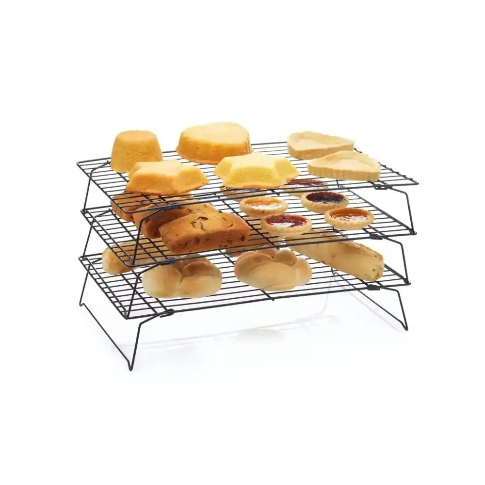 Three-tiered cooling rack with various types of bread and pastries on a white background
