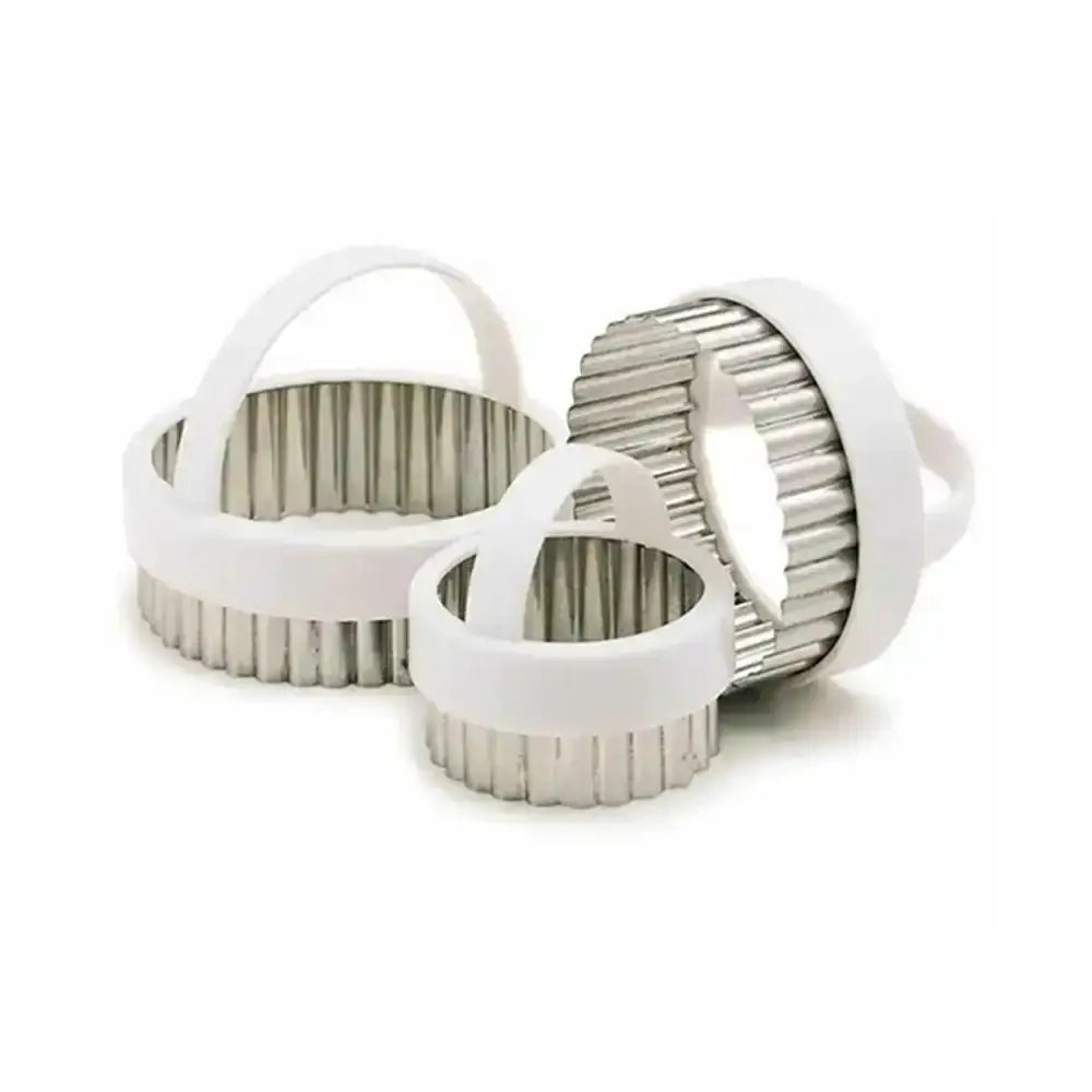 Three metallic kitchen tools with white handles on a white background