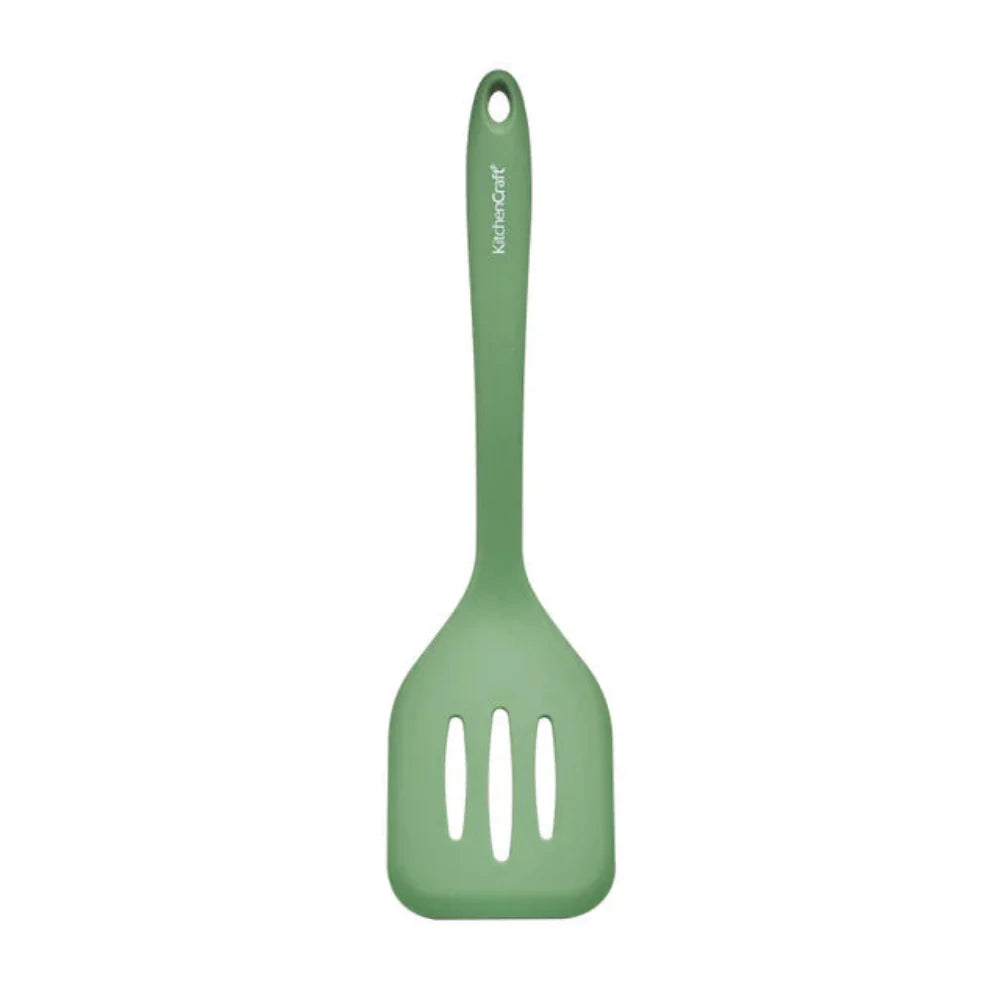 Green slotted spatula on a white background