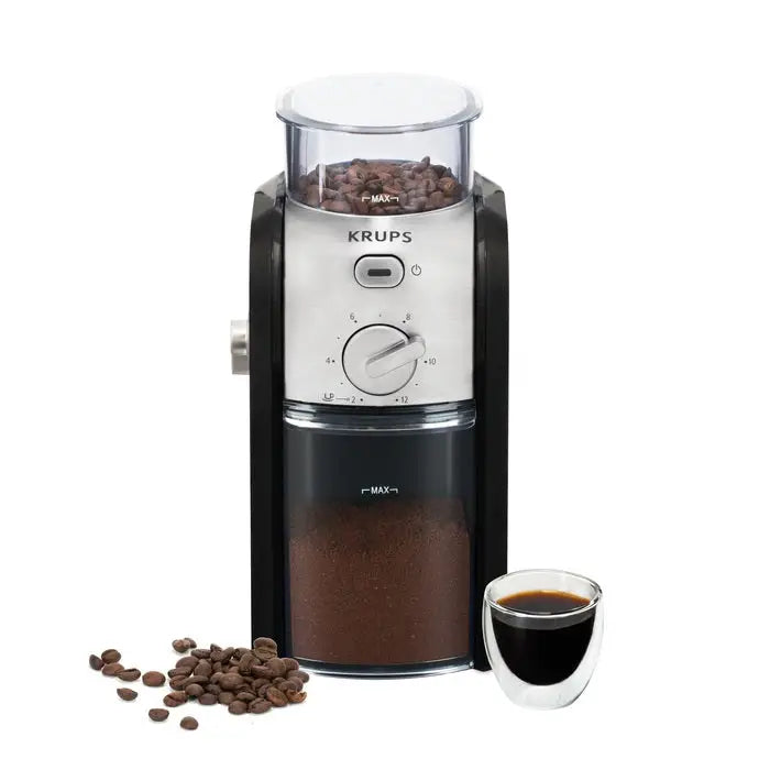 Krups coffee grinder with coffee beans and a cup of coffee on a white background