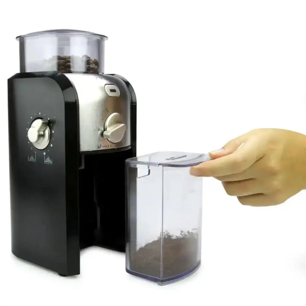 Black coffee grinder with a clear container filled with ground coffee, on a white background.