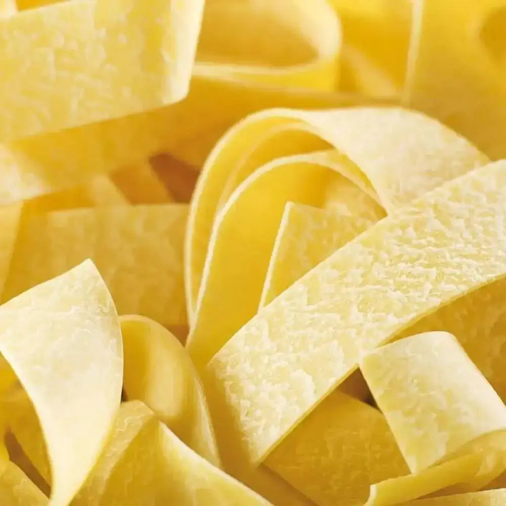 Close-up of uncooked yellow pasta ribbons