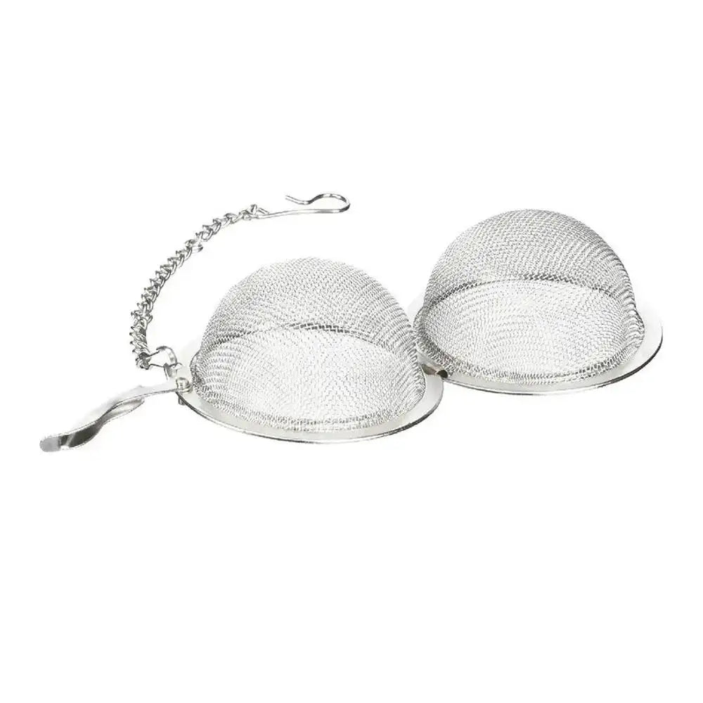 Metallic tea ball infuser on a white background