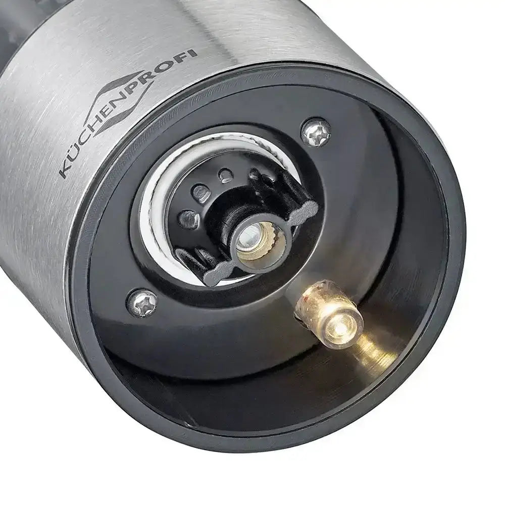 Close-up of the bottom of a salt or pepper grinder with a light with 'Küchenprofi' branding on a white background.