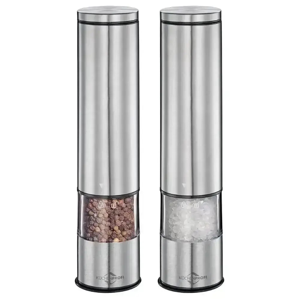 Two silver pepper mills with visible contents on a white background