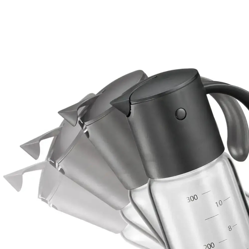 Clear glass oil and vinegar dispenser with black lid and handle on a white background