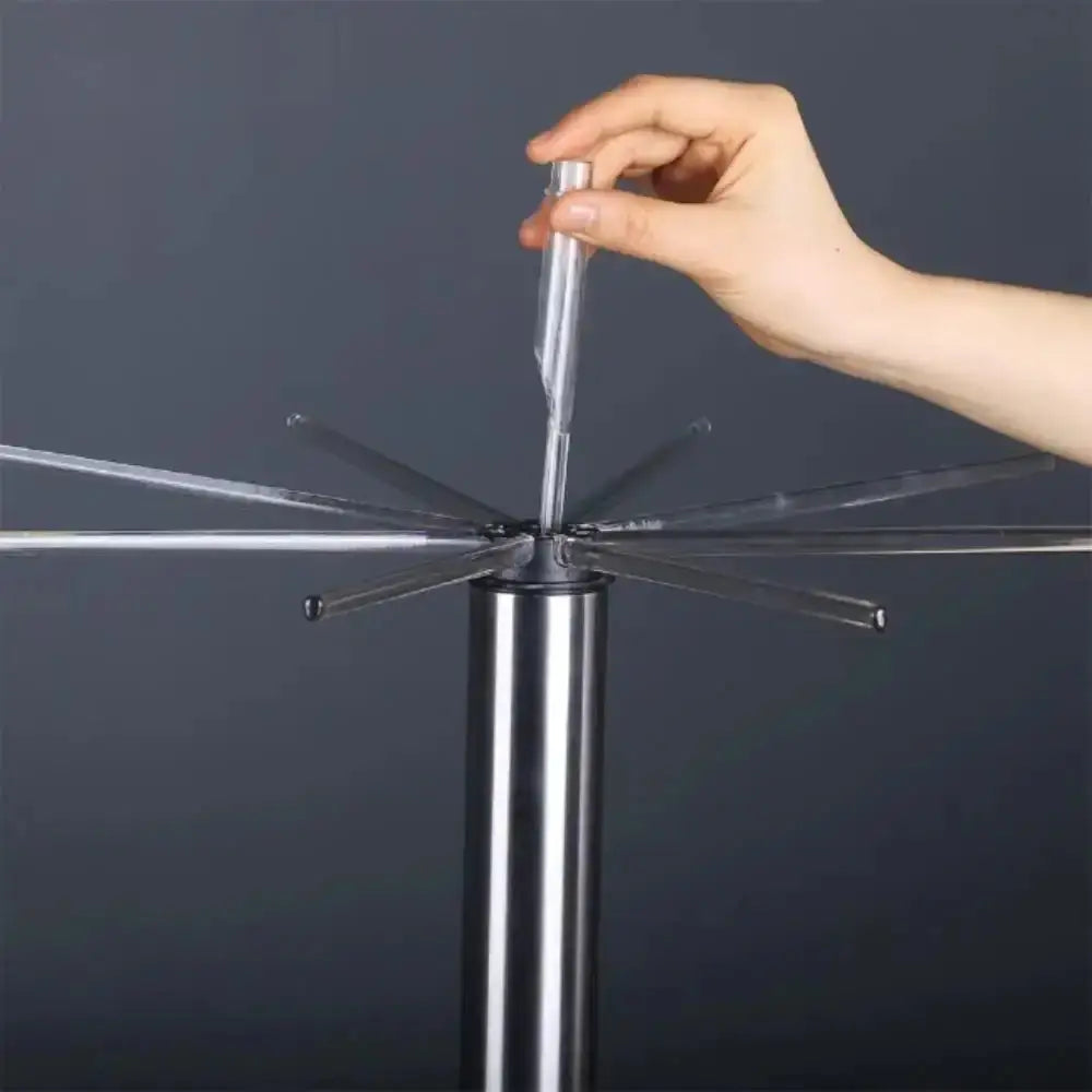 Hand holding pasta drying stands legs against a dark background