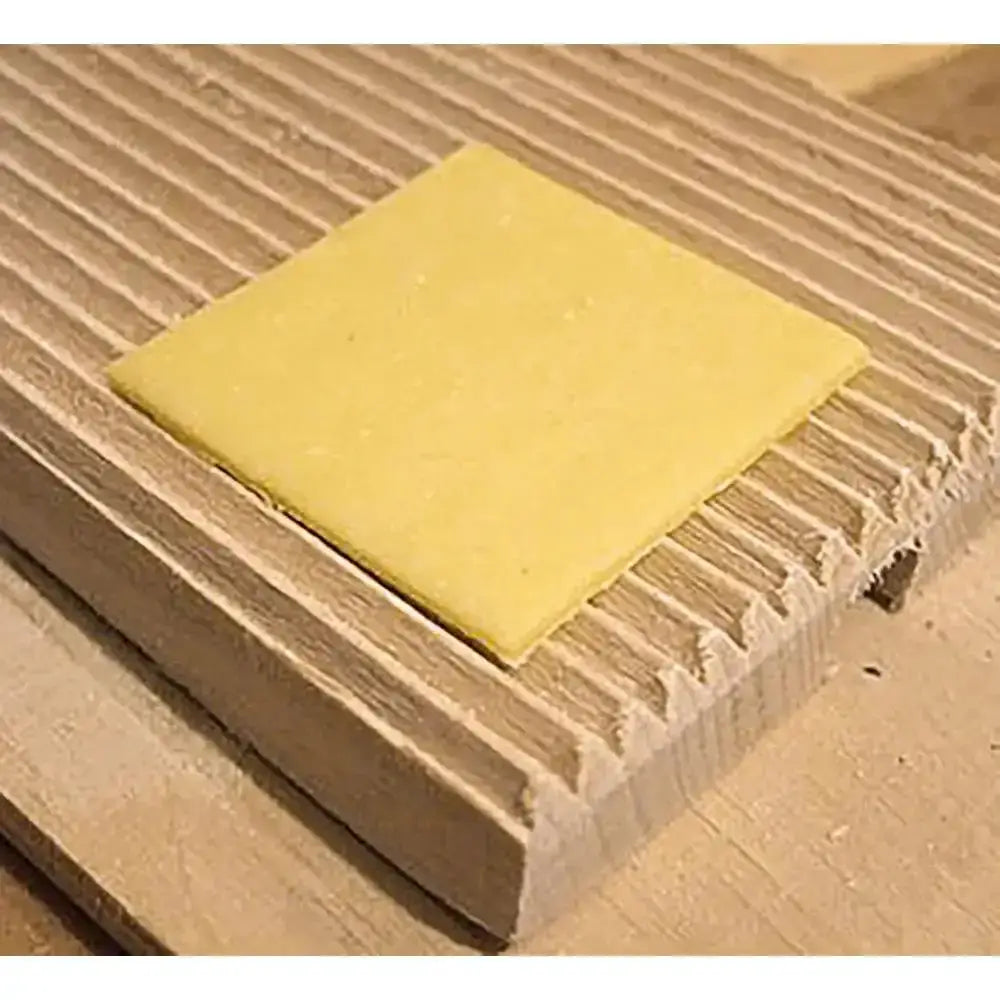 Square of Pasta pastry on a gnocchi shaping board