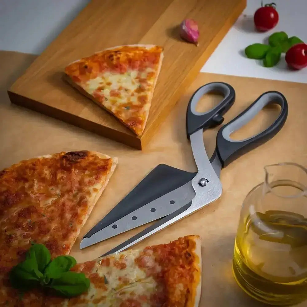 Pizza slices on a wooden board with a pair of pizza scissors and a glass of oil.