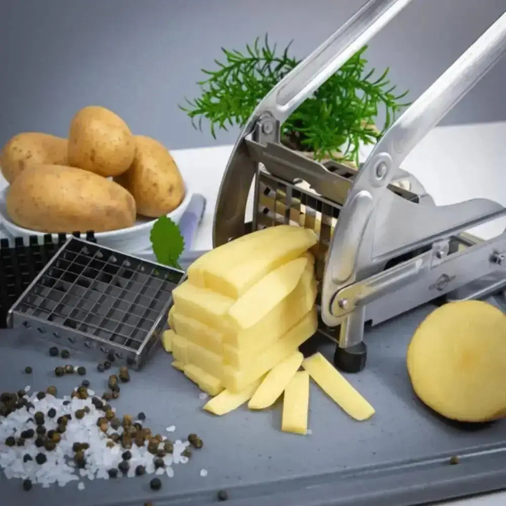 Potato peeler with sliced potatoes on a gray surface