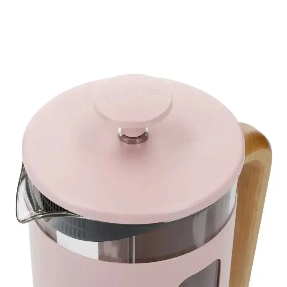 Pink glass coffee press with wooden handle on a white background