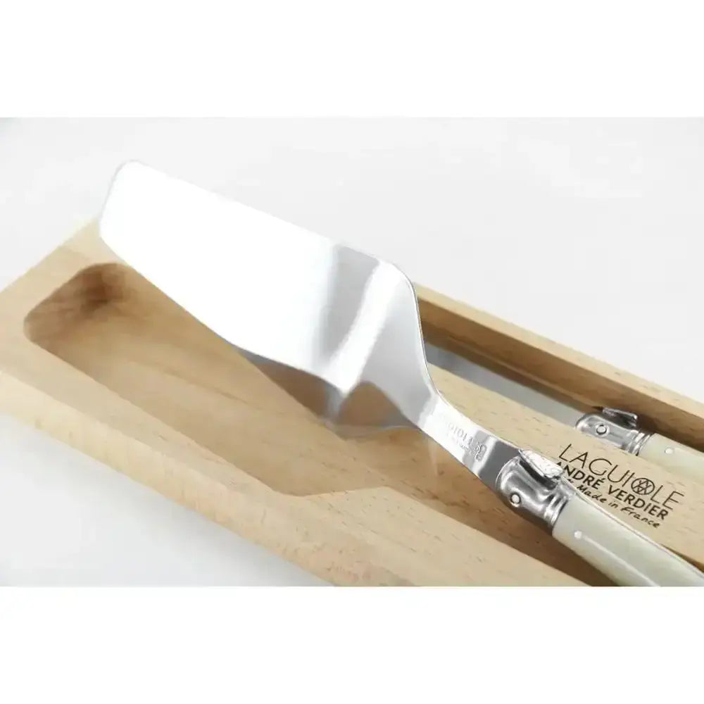 White spatula with wooden handle in a wooden tray on a white background