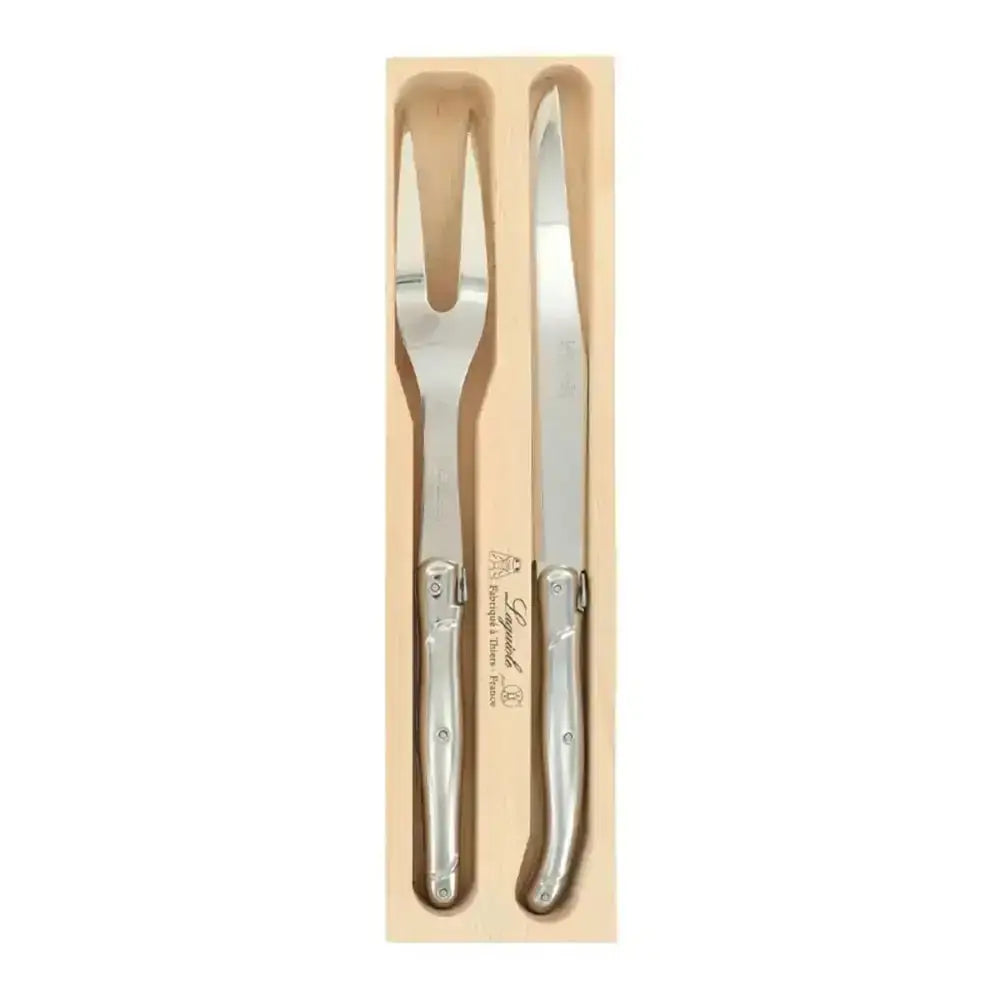 Set of silver cutlery with wooden holder on a white background