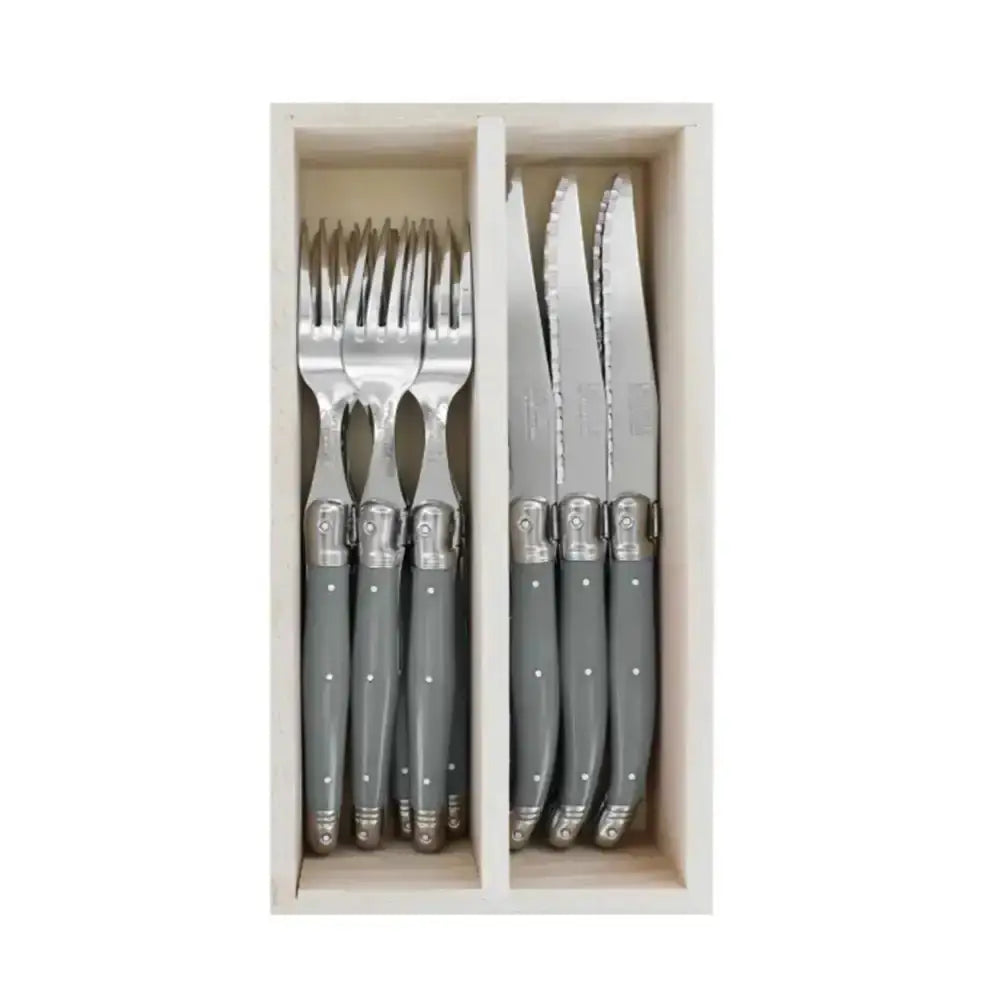 Set of gray cutlery with silver handles in a wooden box on a white background