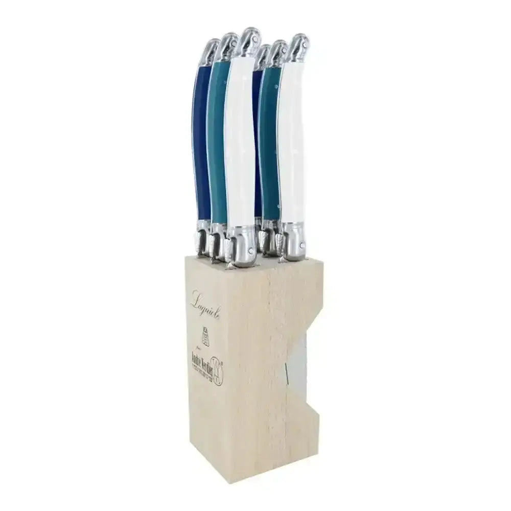 Set of knives with blue and silver handles in a wooden block on a white background