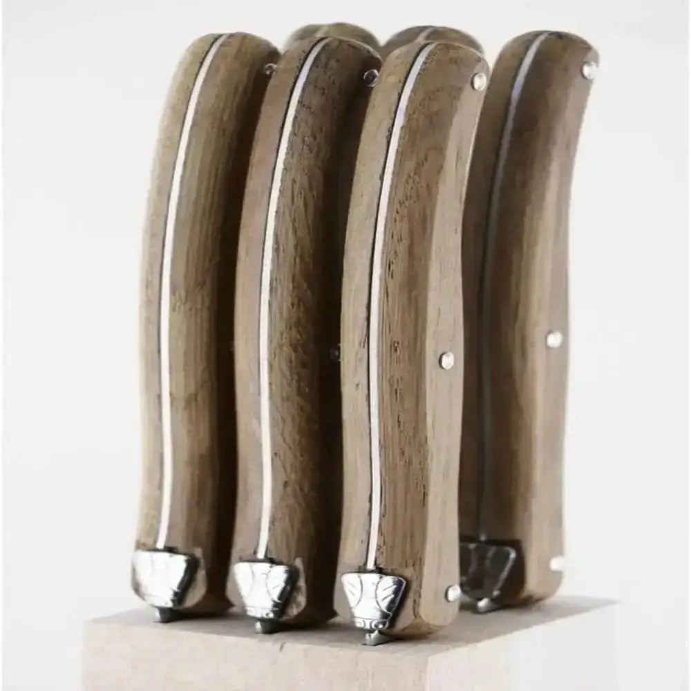 Four wooden handles with metal tips on a white background