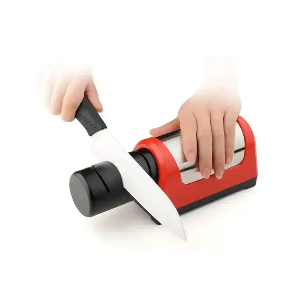 Person using a red and black knife sharpener with a white background