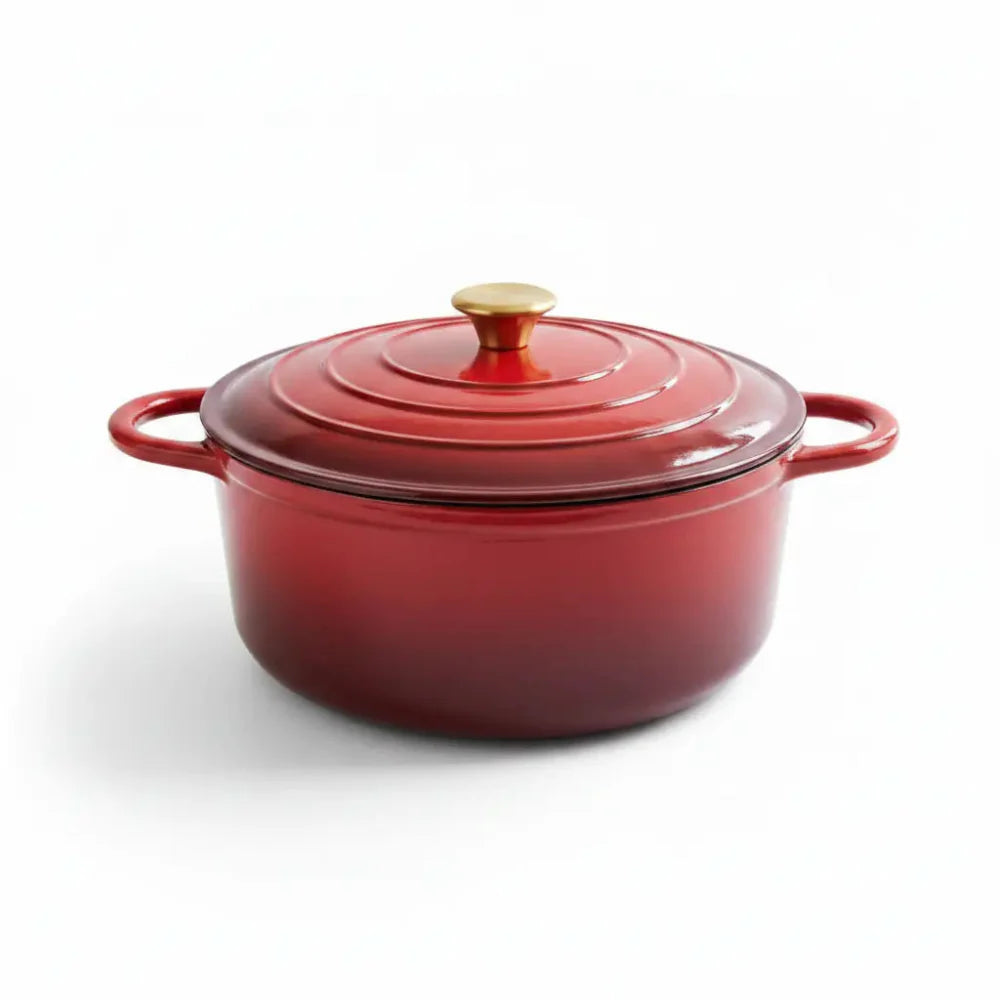 Red enameled cast iron Dutch oven with a lid on a white background