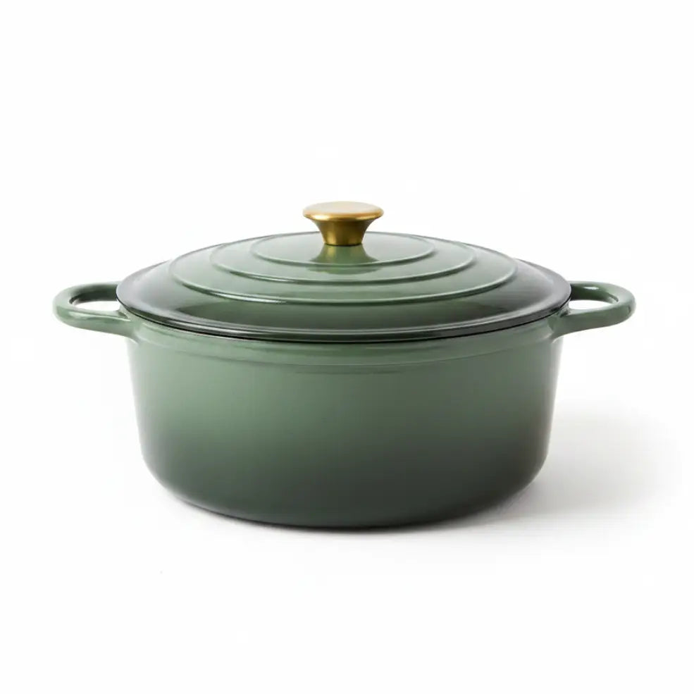 Green enameled cast iron Dutch oven with a gold knob on a white background