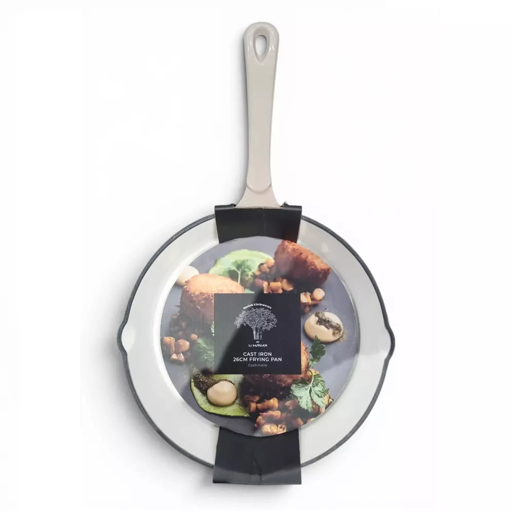 Beige cast iron frying pan with a beige handle on a white background