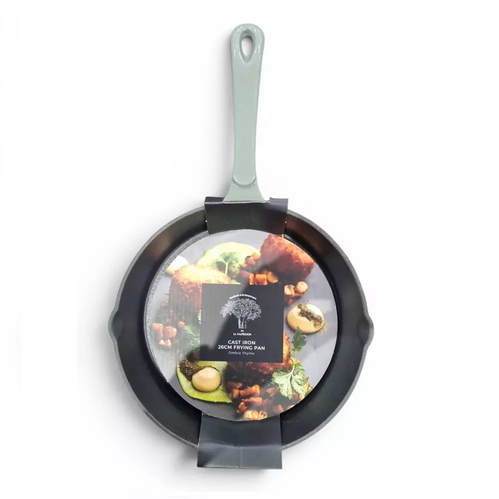 Green cast iron frying pan with a green handle on a white background