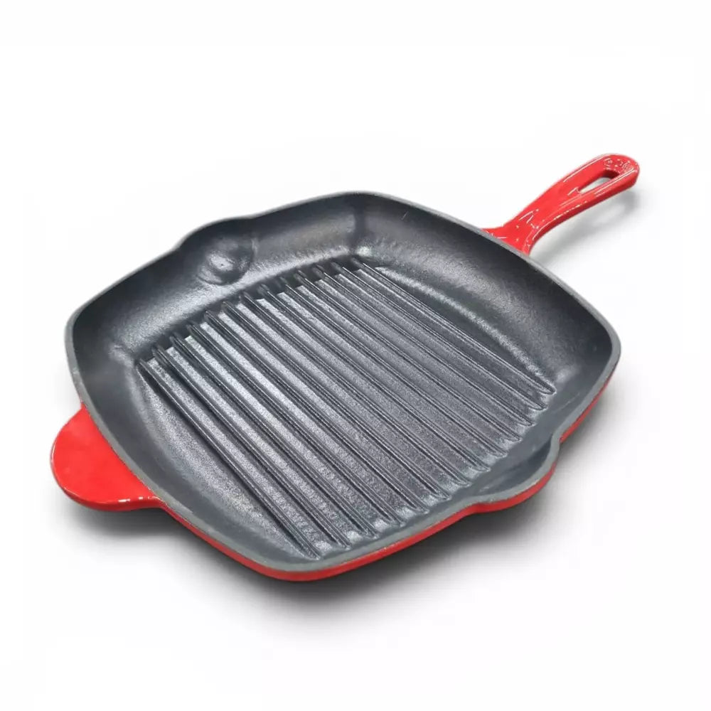 Red cast iron grill pan with red handle on a white background