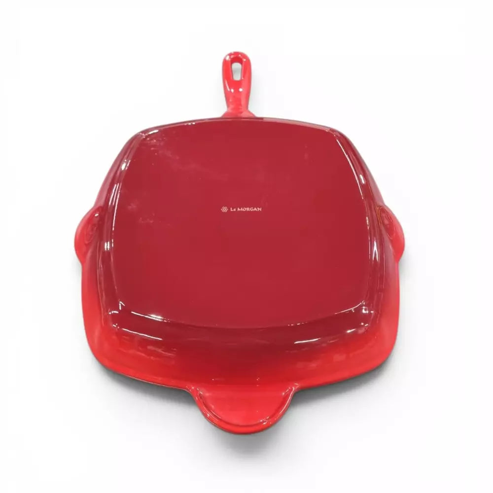 Red cast iron enamel grill pan on white background