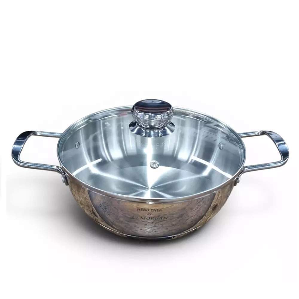 Stainless steel pot with glass lid on a white background