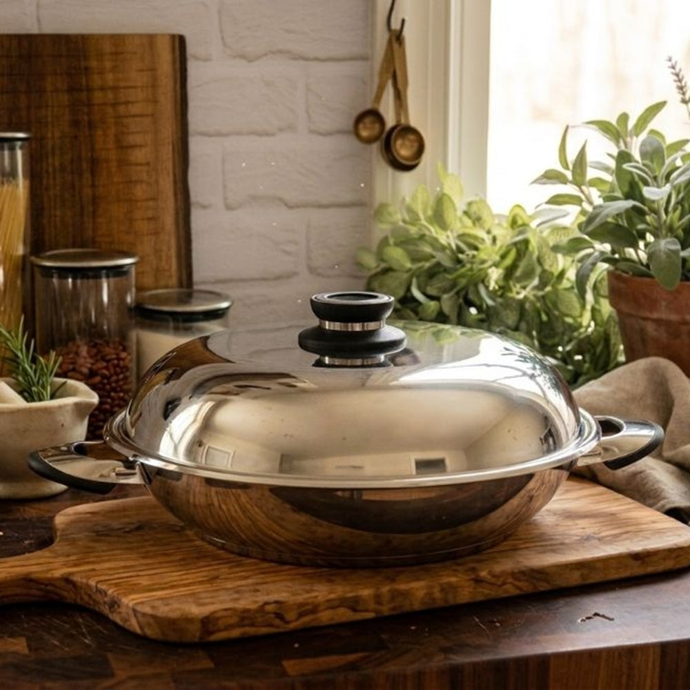 Stainless steel pot with lid on a wooden cutting board in a kitchen setting