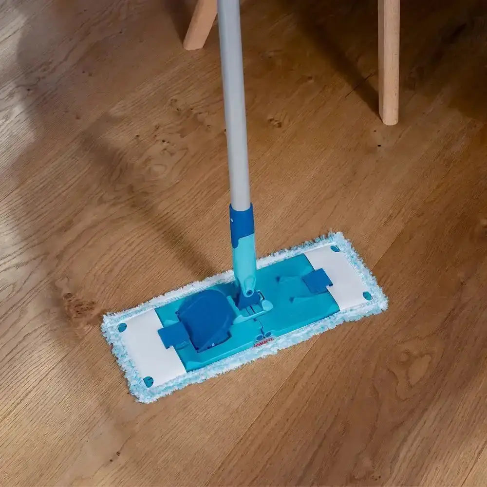 Blue and white cleaning mop on a wooden floor