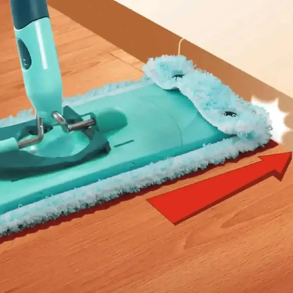 Turquoise cleaning tool with a white scrubber pad on a wooden floor.