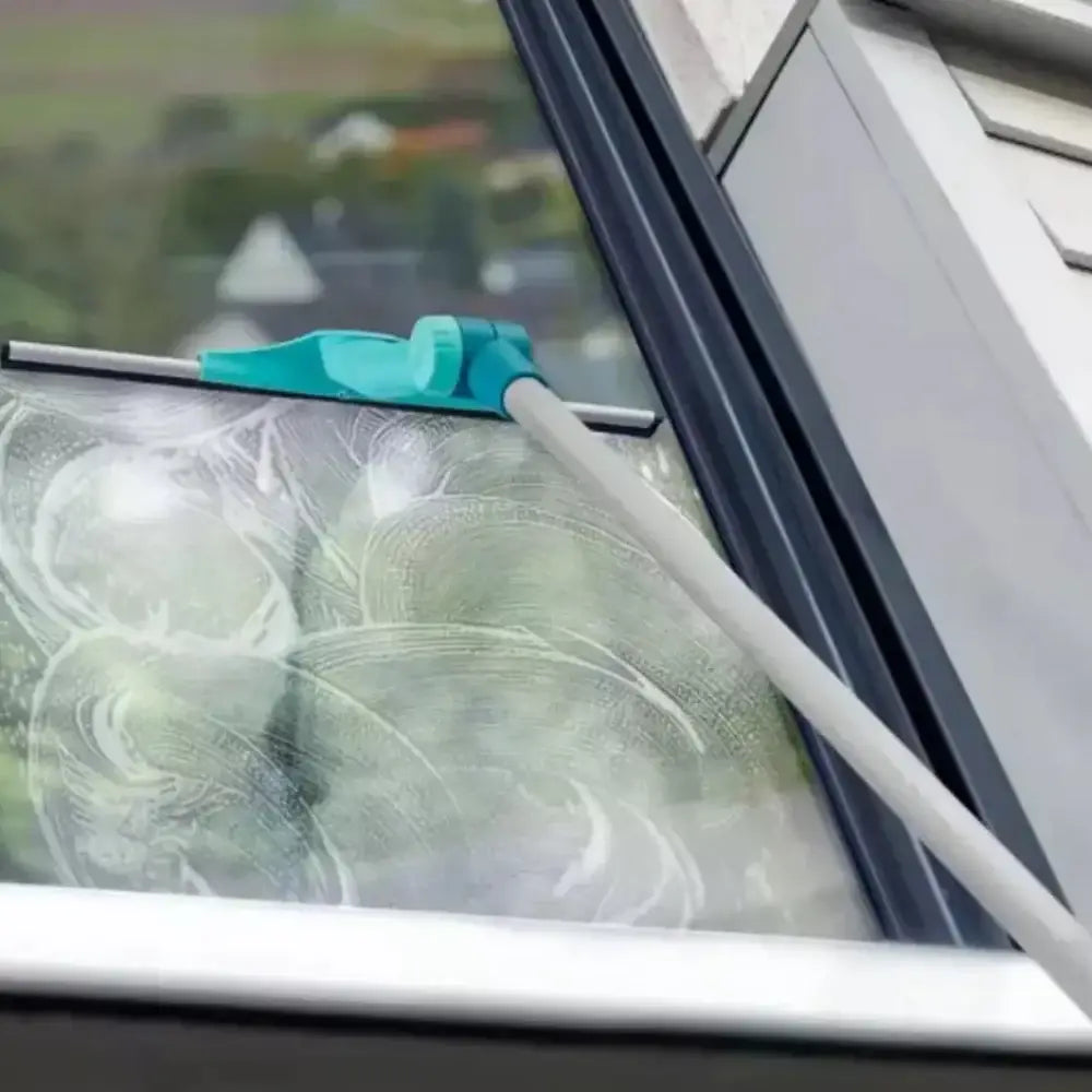 Window cleaning tool with a green cloth cleaning a window