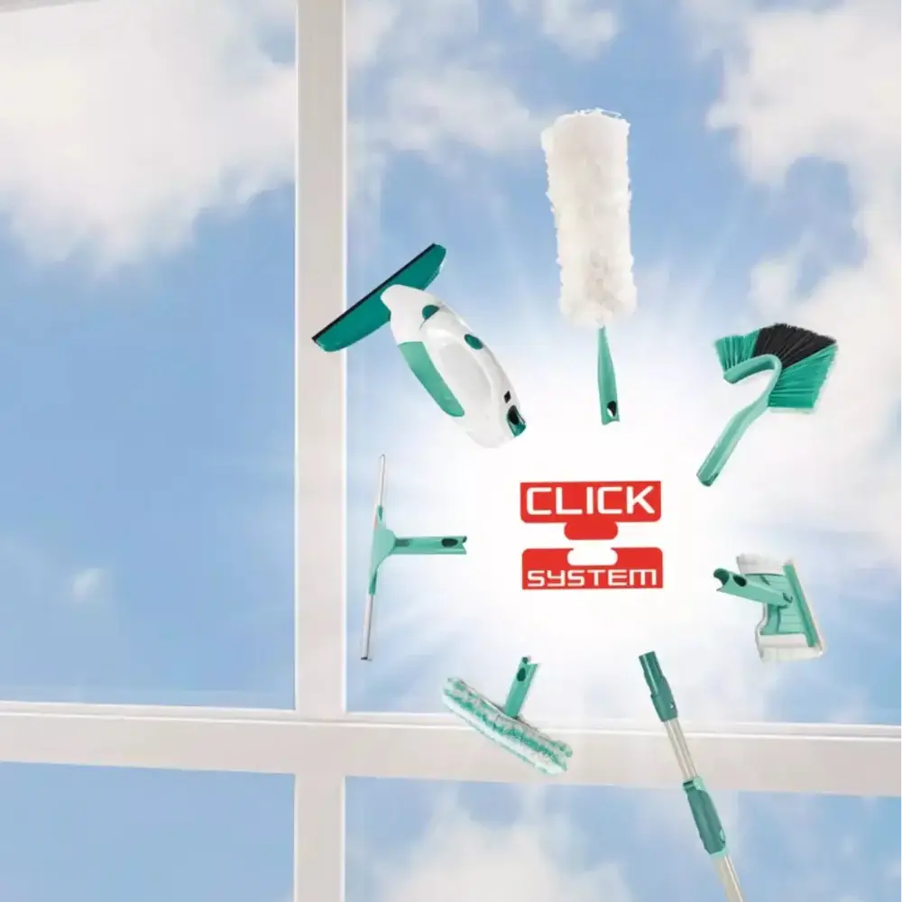 Window cleaning tools with CLICK SYSTEM branding in front of a window with a blue sky view.