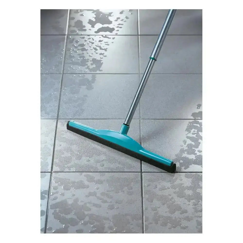 Turquoise floor squeegee cleaning a wet tiled floor