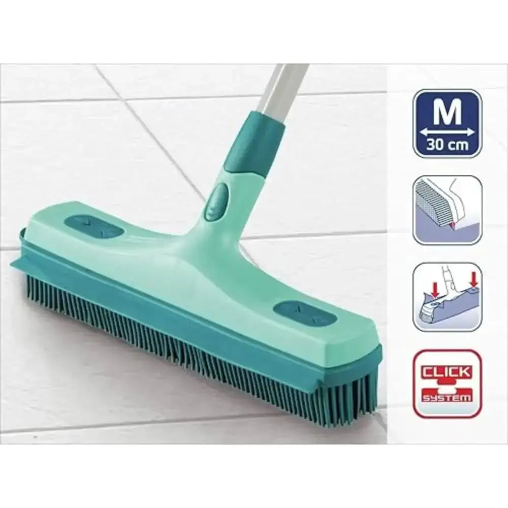 Green cleaning brush with a telescopic handle on a white floor background