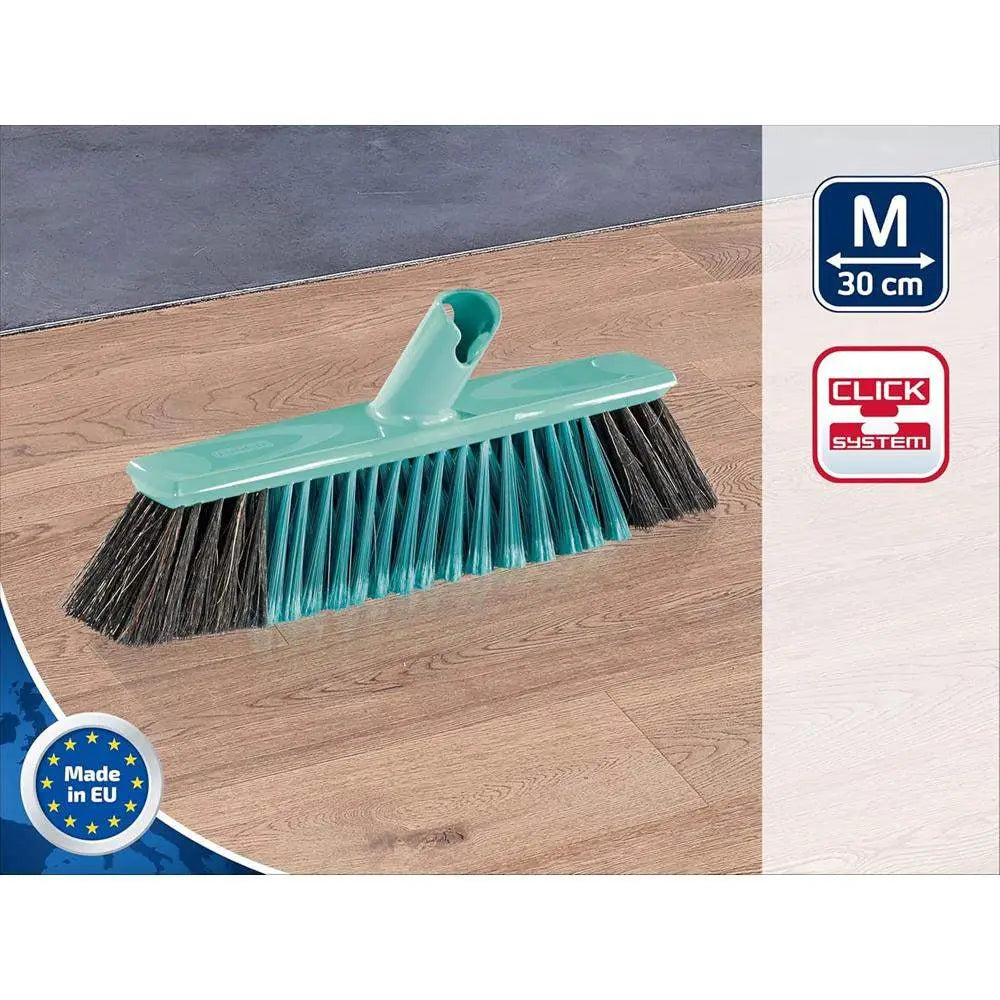 Green push broom with black bristles on a wooden floor, featuring 'Made in EU' and 'Click System' logos.