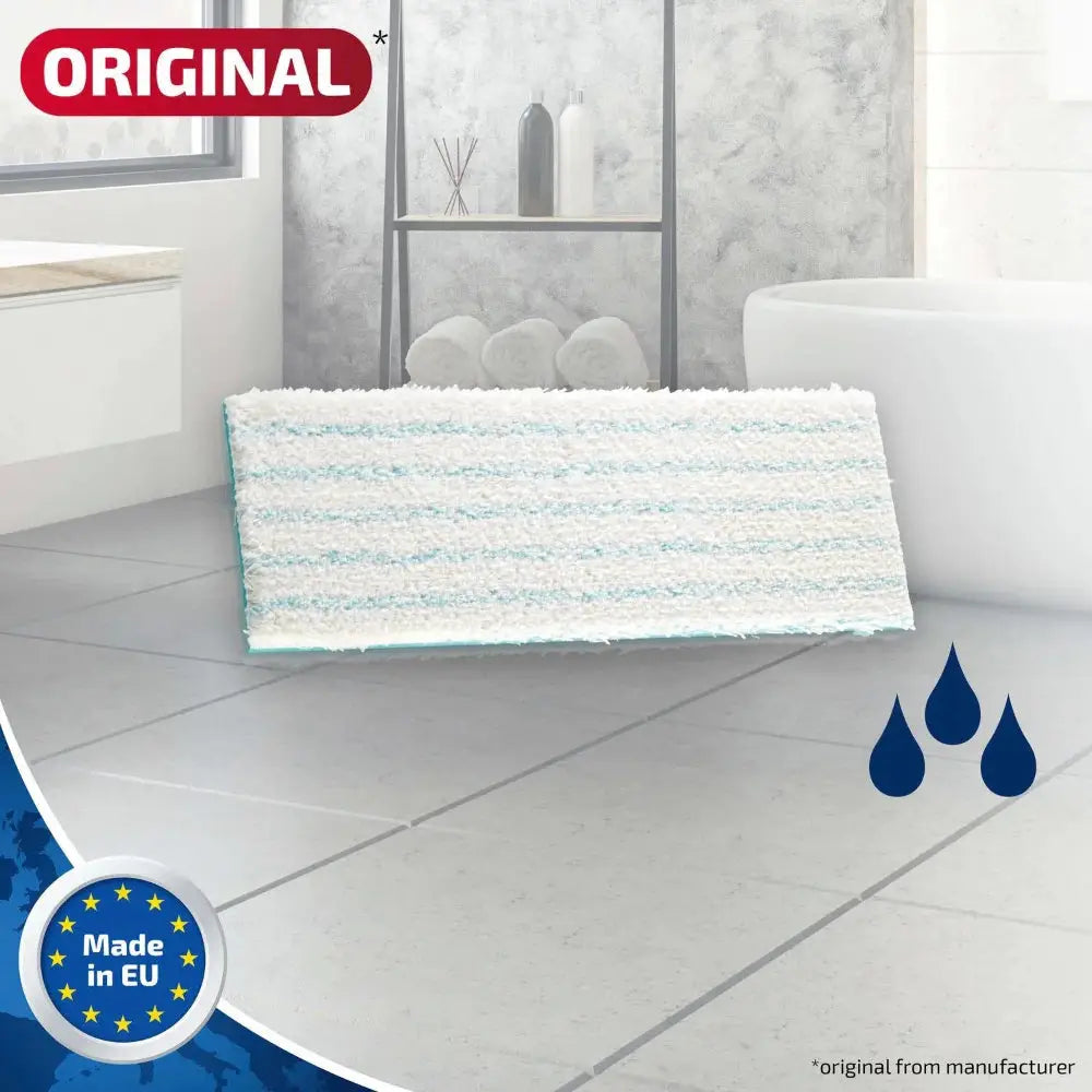 Cotton plus bath mat with washing instructions and brand logo on a tiled floor.