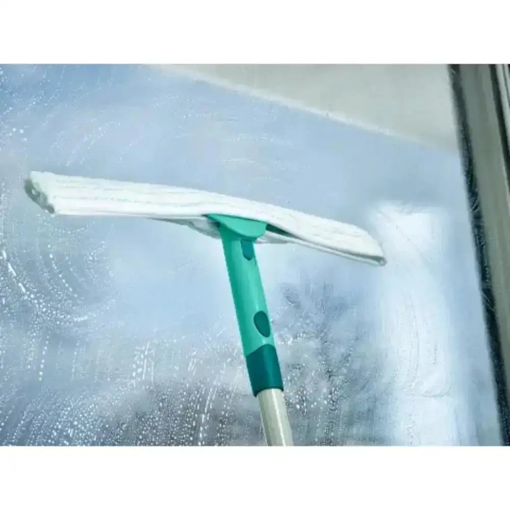 Window cleaning tool with a squeegee on a glass surface