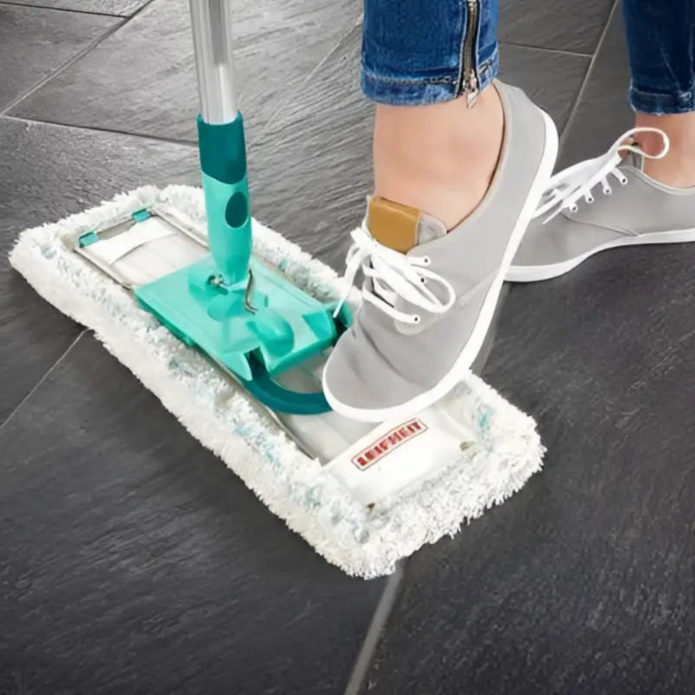 Person using a microfiber mop on a dark tiled floor