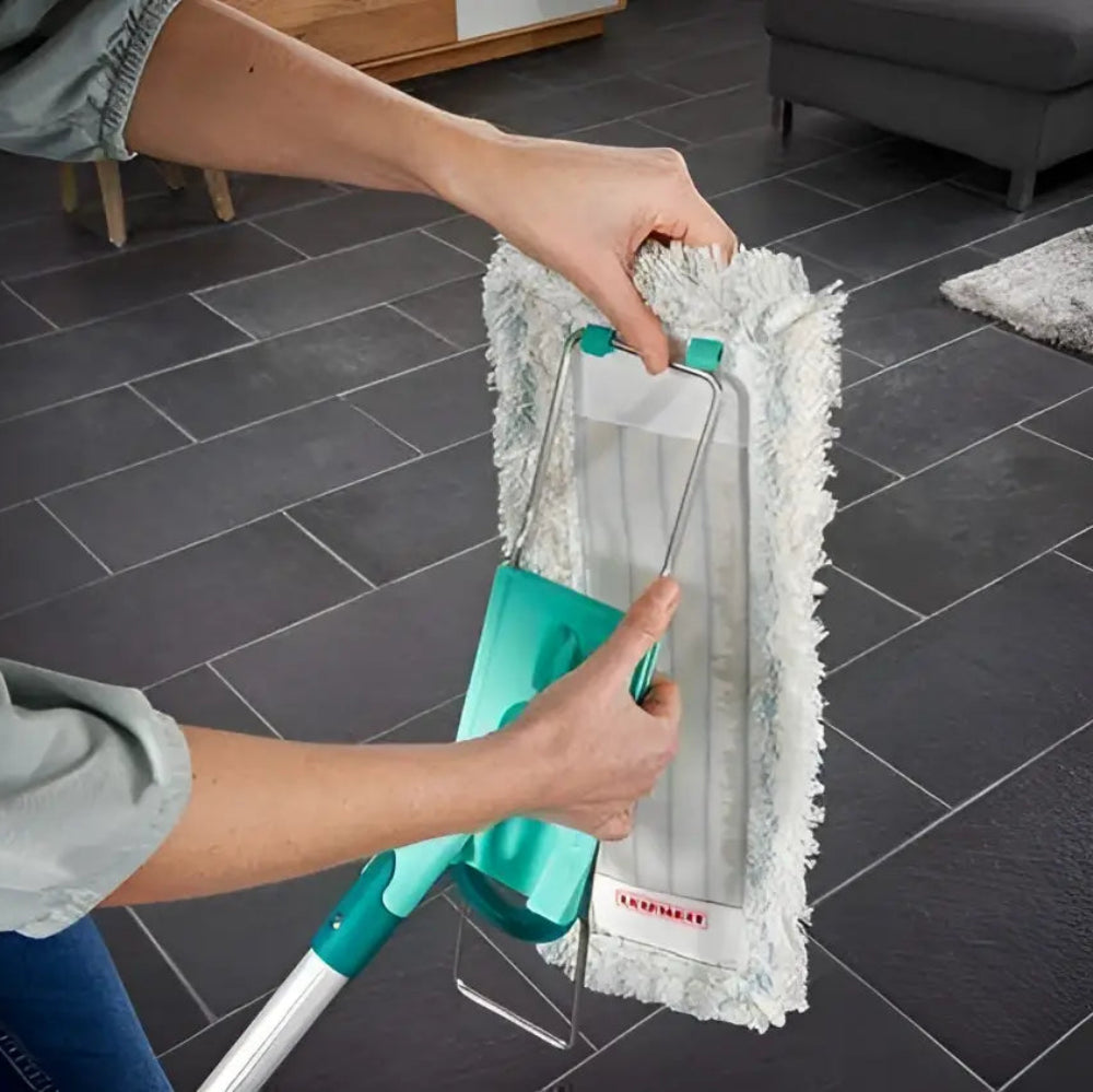 Person cleaning a dark tiled floor with a microfiber mop.