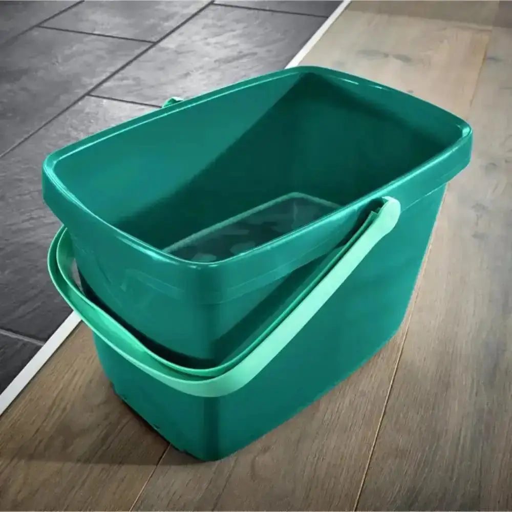 Two green buckets stacked on a wooden floor.