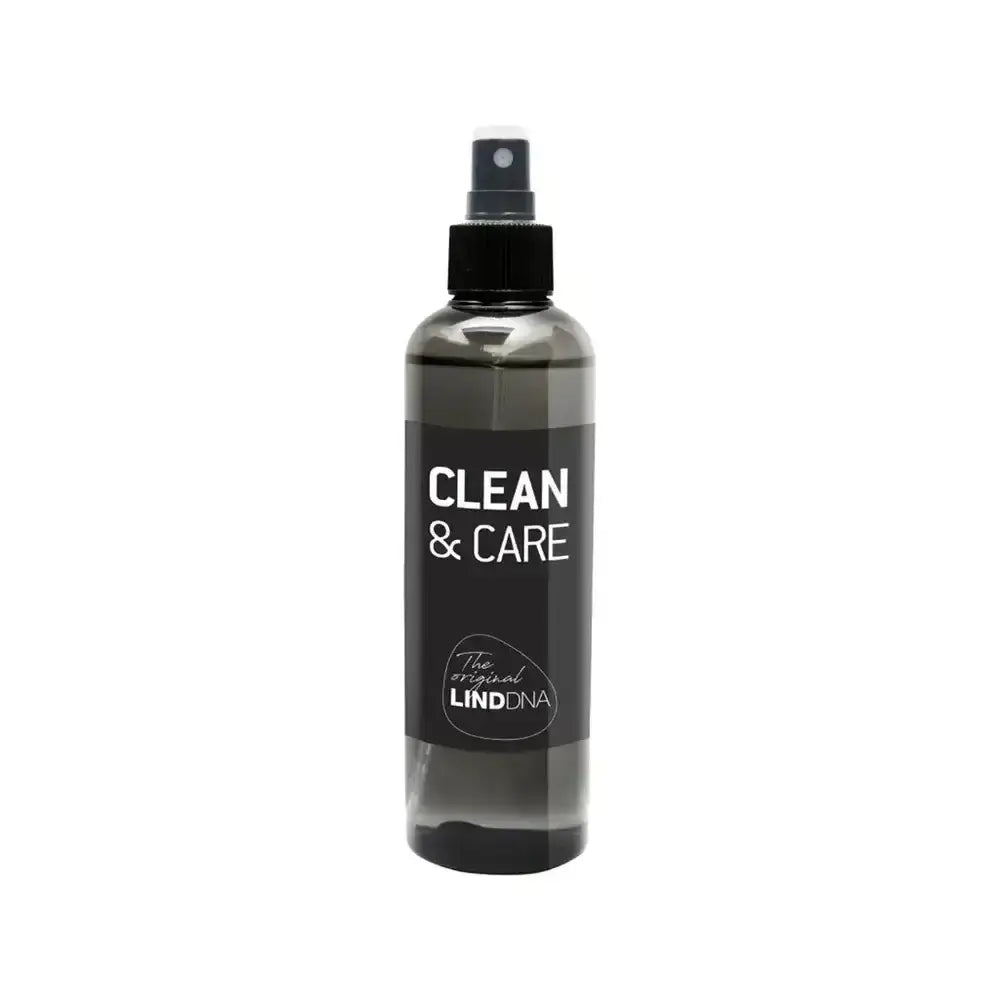 Bottle of 'Clean & Care' spray with black label on a white background