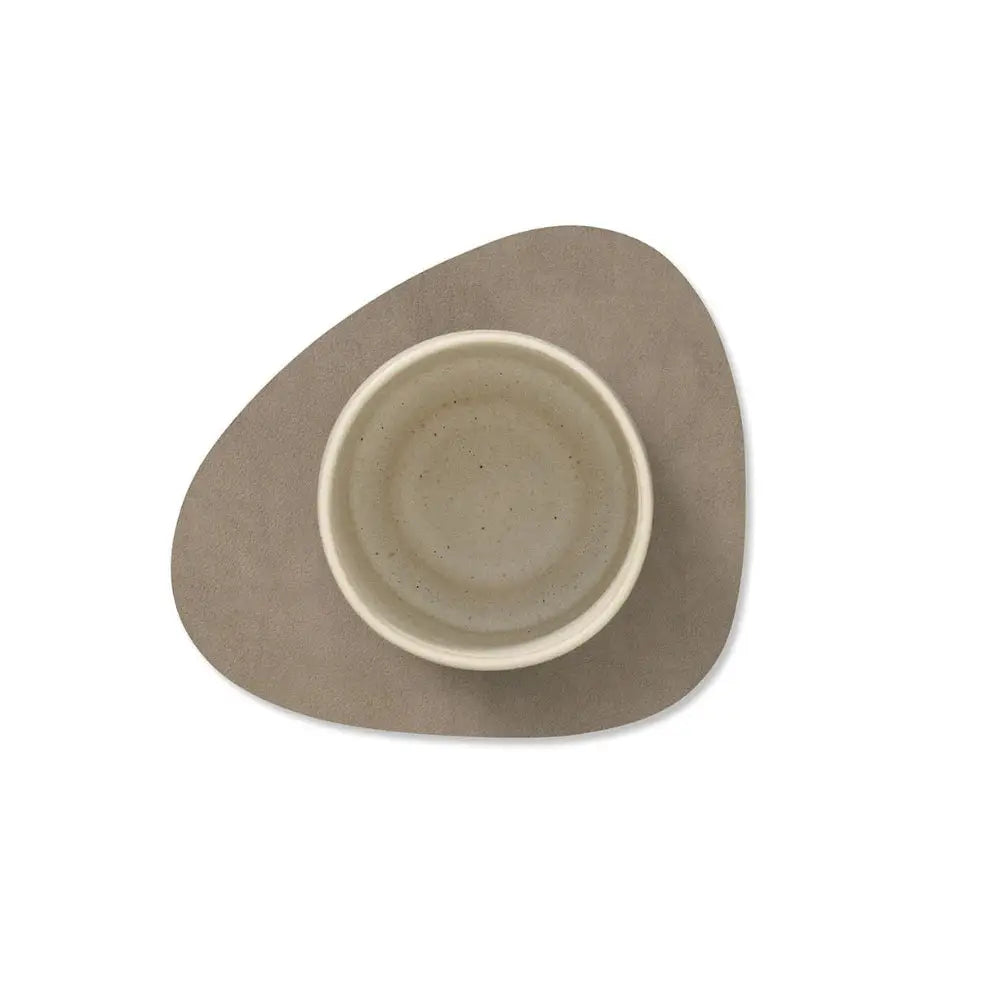 Triangular ceramic dish with a smaller circular dish inside on a white background