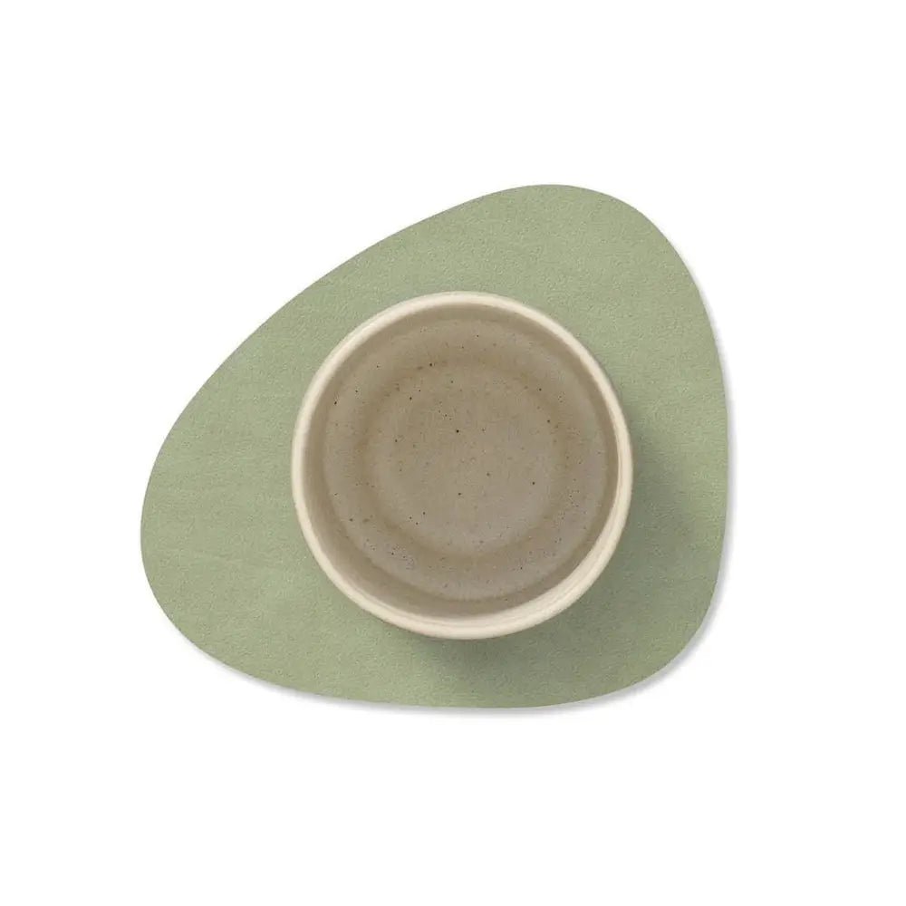 Greencoaster with a ceramic mug on a white background