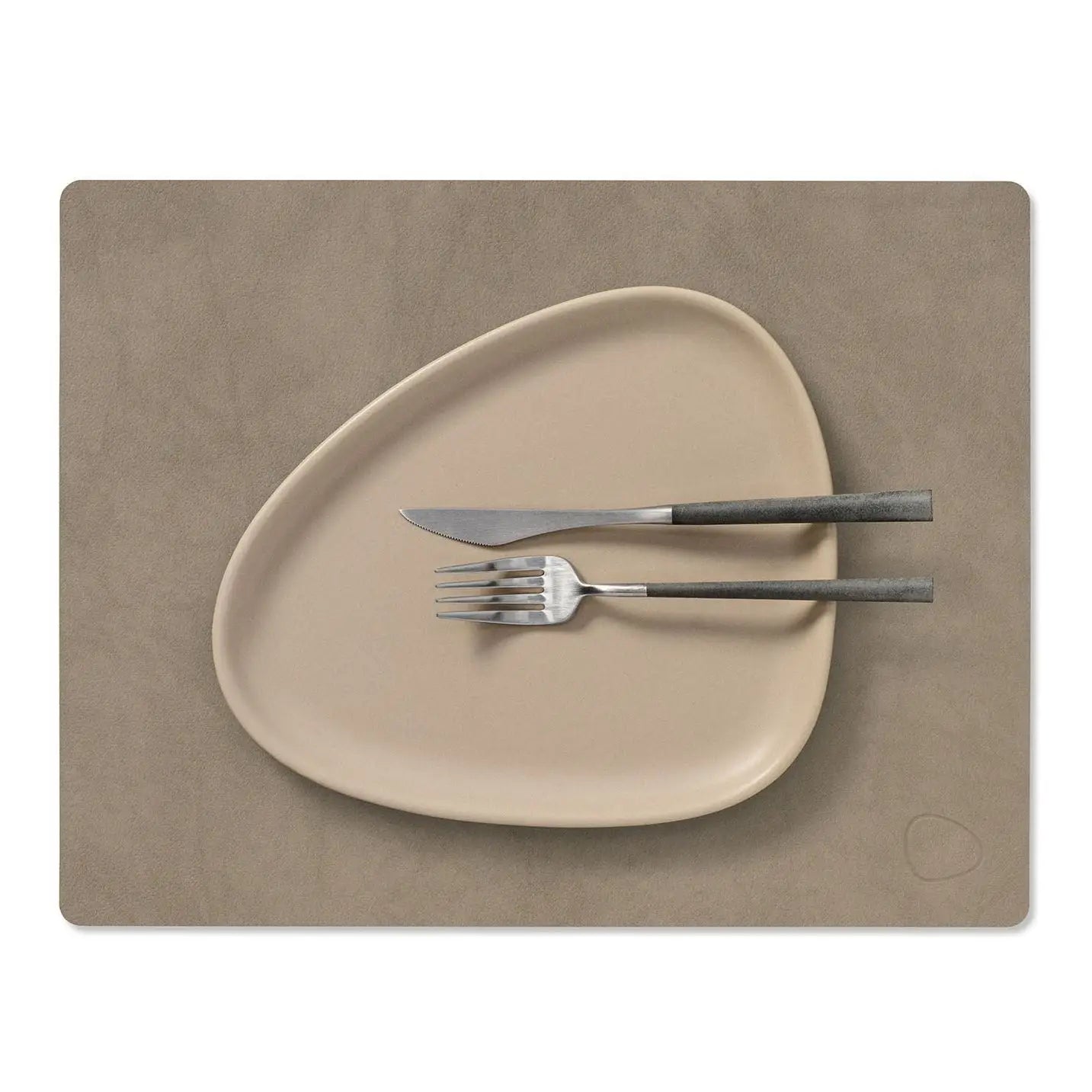 Beige plate with fork and knife on a matching placemat on a white background