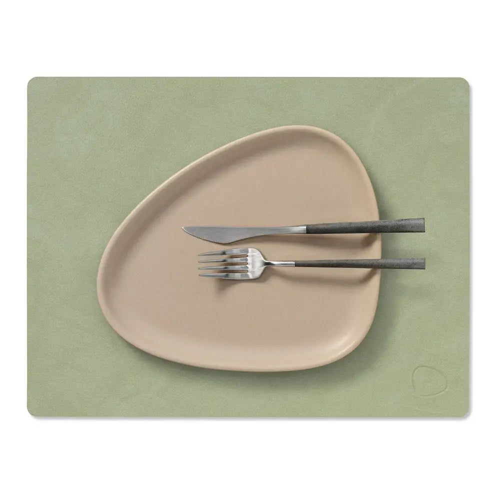 Olive green leather placemat with a plat and knife and fork