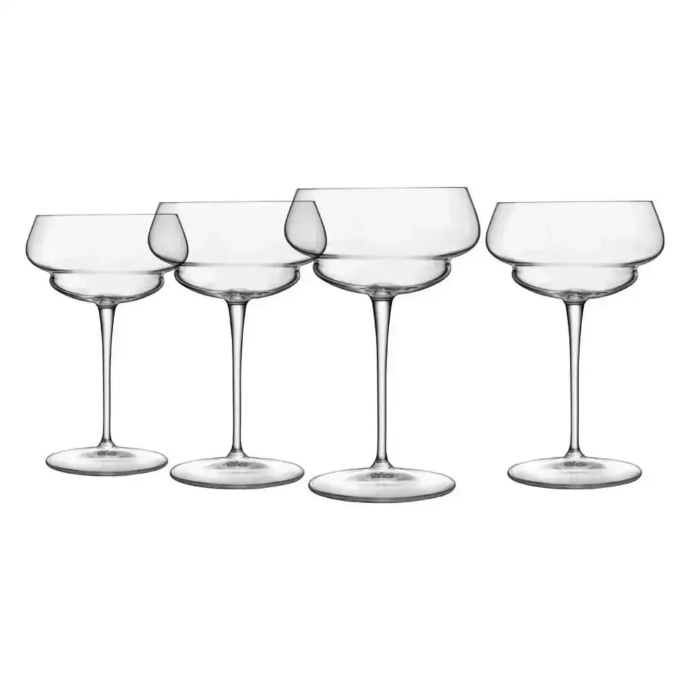 Set of five clear glass champagne coupes on a white background