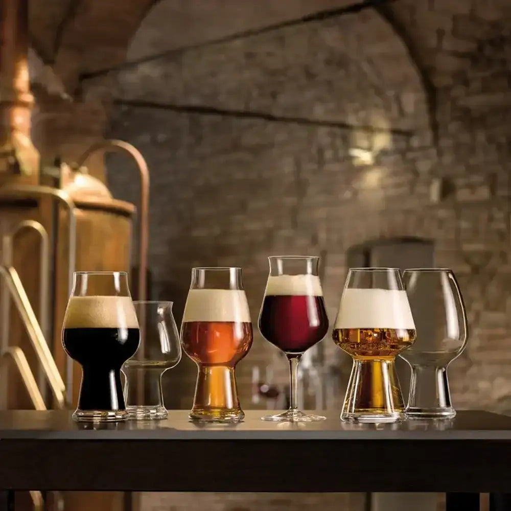 Set of beer glasses with different types of beer on a bar counter.